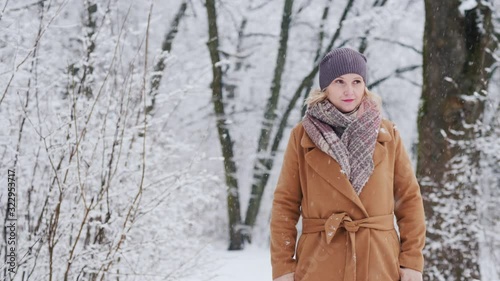 Stylish woman walks through snowy park photo