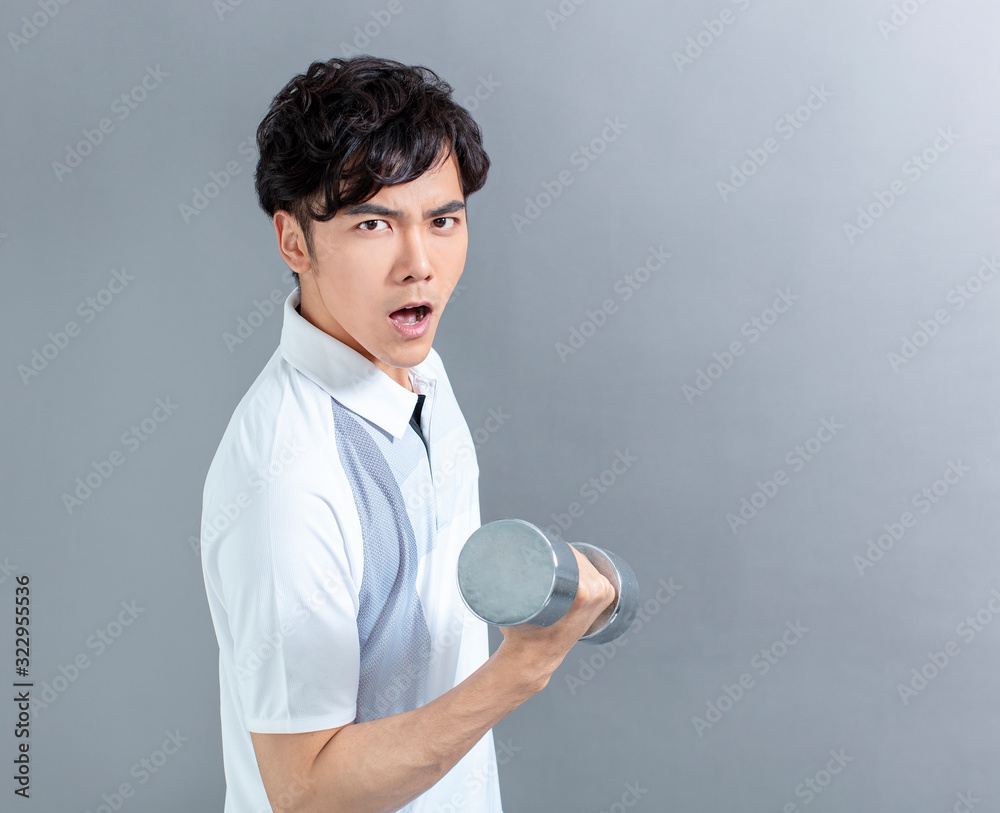 asian young man doing exercise with dumbbell asian young man doing exercise with dumbbell