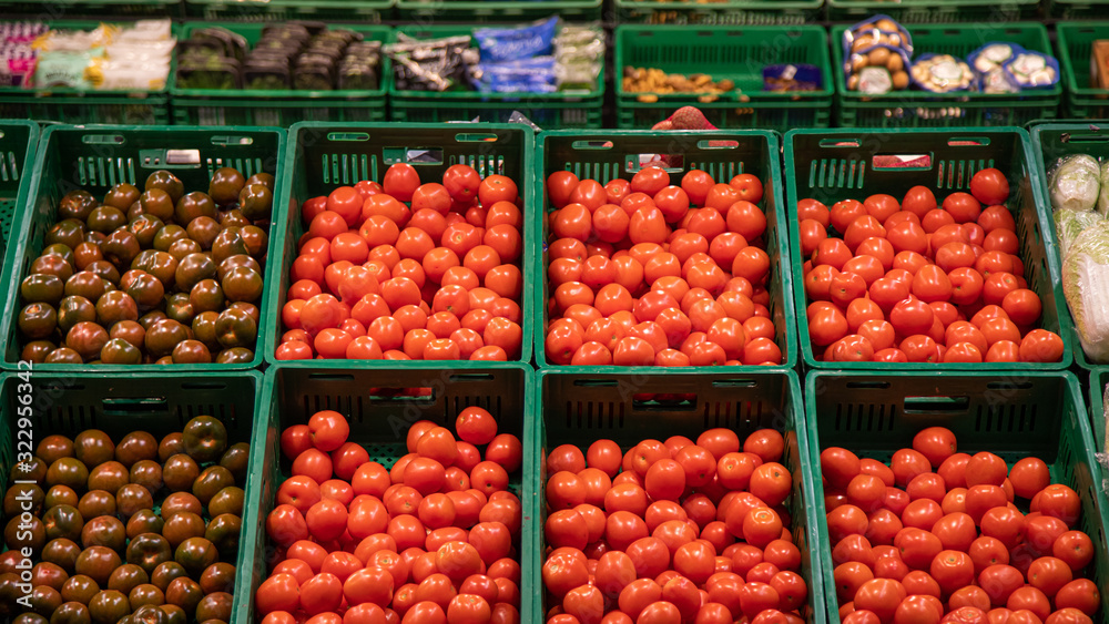Top view of fresh red tomatoes on the store shelf.