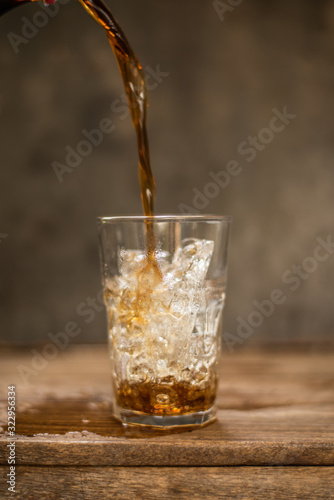 Soft drink splashing on wood table.