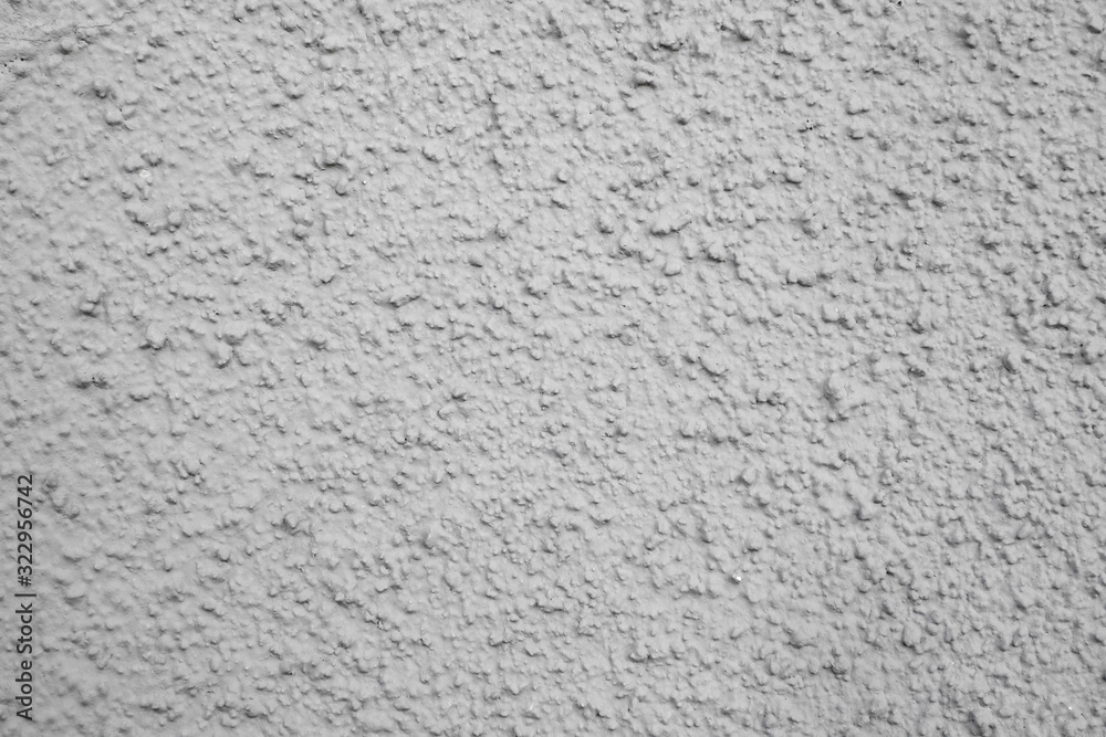 Rough texture of the gray wall, the facade of the house with a convex structure of plaster Rough texture of the gray wall, the facade of the house with a convex structure of plaster