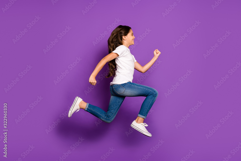 Full length body size profile side view of her she nice attractive lovely purposeful cheery wavy-haired girl jumping running isolated on bright vivid shine vibrant purple violet lilac color background