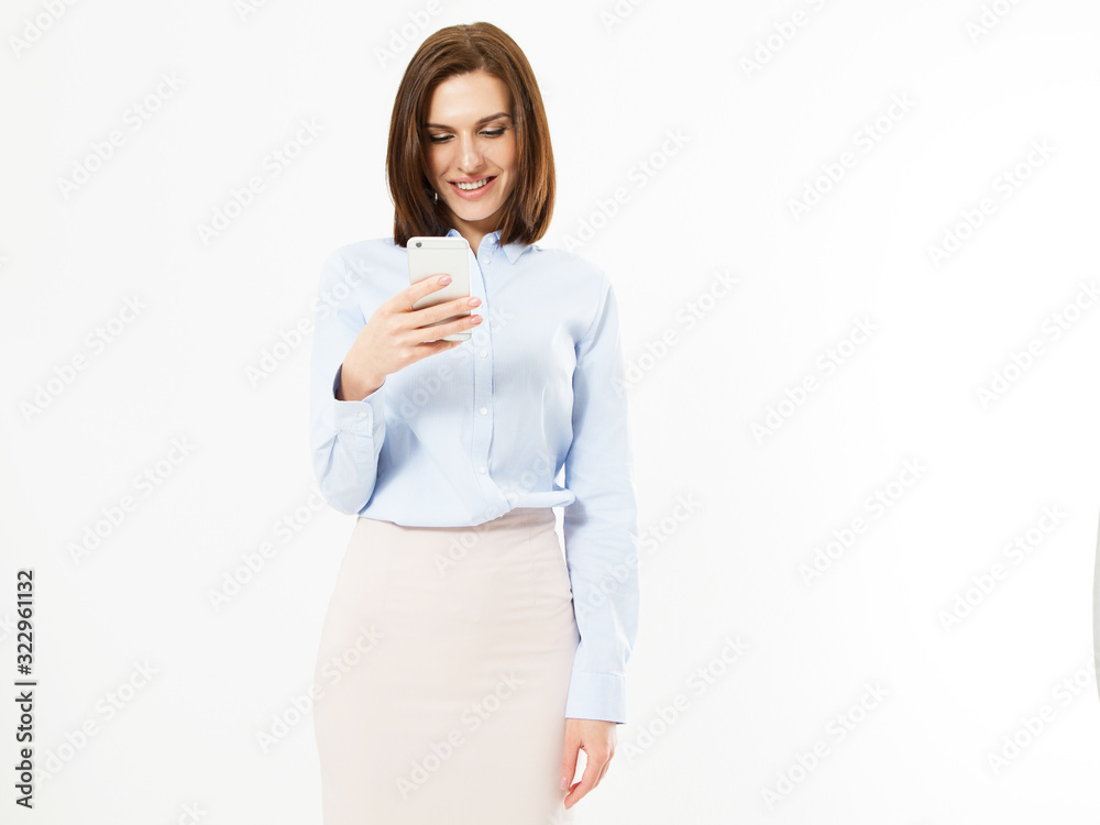 Modern smiling woman looks at something interesting in a mobile phone isolated, girl holding phone Modern smiling woman looks at something interesting in a mobile phone isolated, girl holding phone
