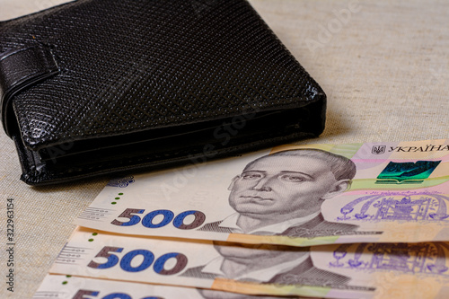 Five hundred Ukrainian hryvnia banknotes in black purse.