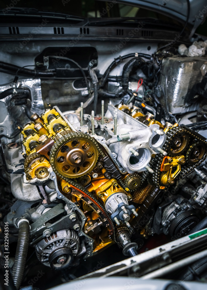 Car repair: type of open engine with drive chains and a large number of pulleys and parts.