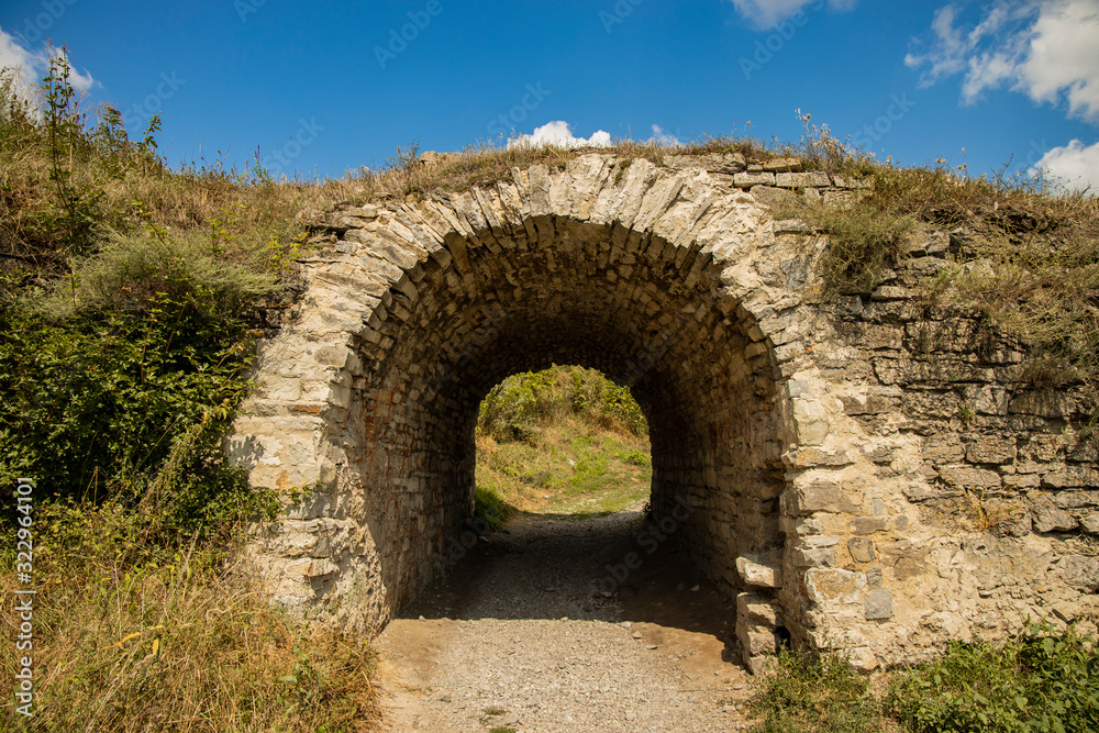 ancient ruins of castle wall tunnel arch shape passage country side outdoor environment