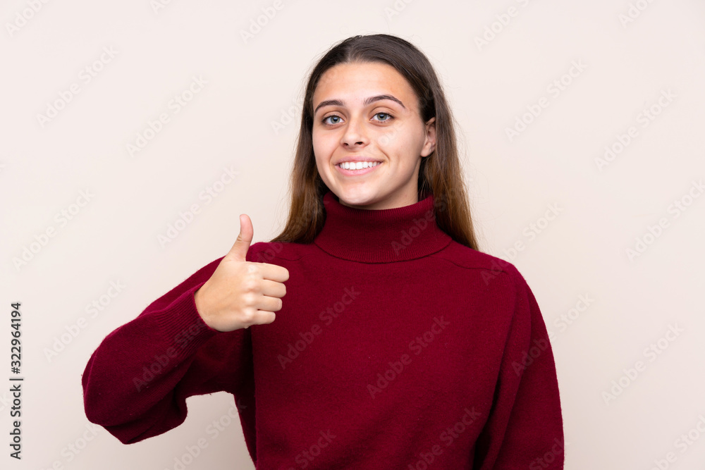 Teenager girl over isolated background giving a thumbs up gesture Teenager girl over isolated background giving a thumbs up gesture