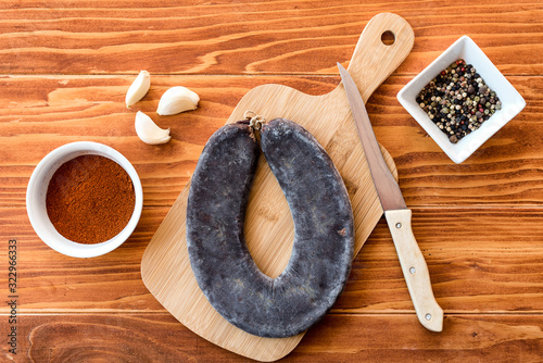 Special Pirot horseshoe ironed sausage - Peglana Pirotska kobasica, made from veal, sheep and goat meat, with addition of garlic, mixed pepper, powdered chili peppers and spices, on a cutting board an photo