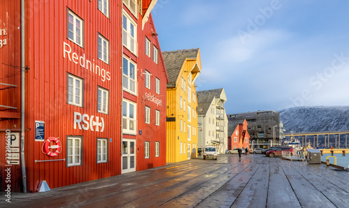 Wooden quay and colourful houses in Tromsø. Visit with Hurtigruten.