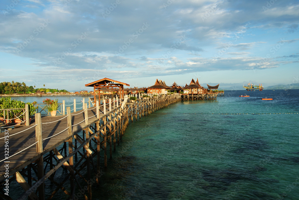Obraz premium houses on the water against the turquoise sea and cloudy sky