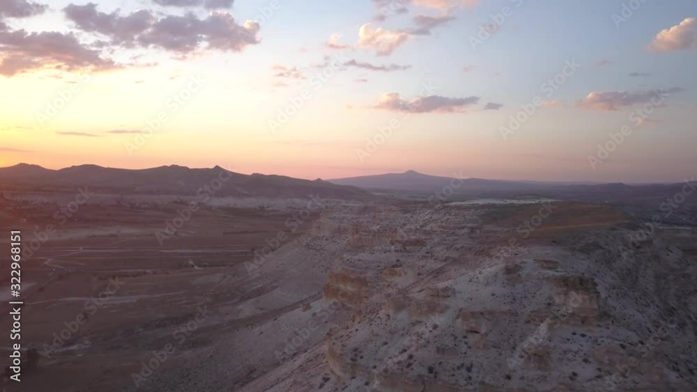 Mountains with rocky hills and amazing colorful sky during sunset, Cappadocia