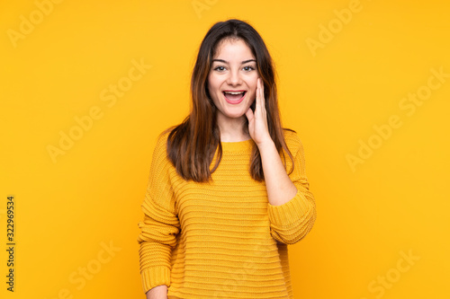 Young caucasian woman isolated on yellow background with surprise and shocked facial expression