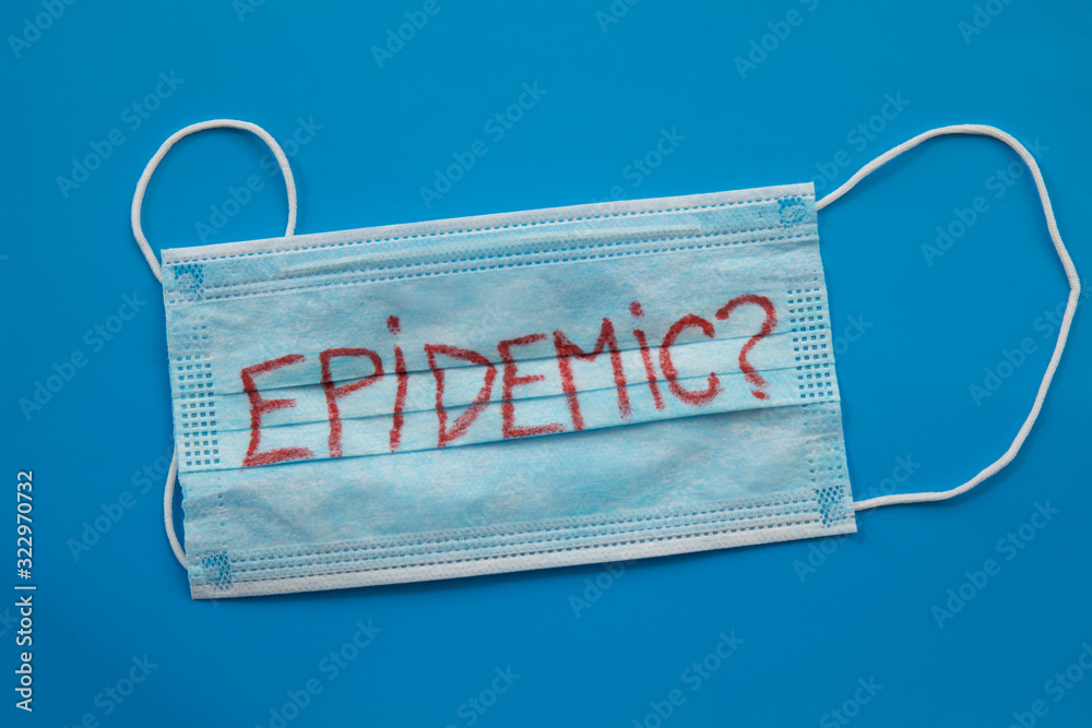 Medicine mask with Epidemic word on blue background Medicine mask with Epidemic word on blue background