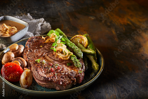 Seasoned thick grilled beef steak with asparagus