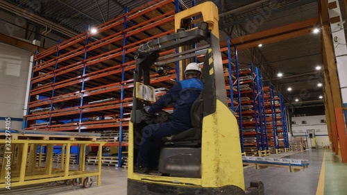 Loader rides along the warehouse