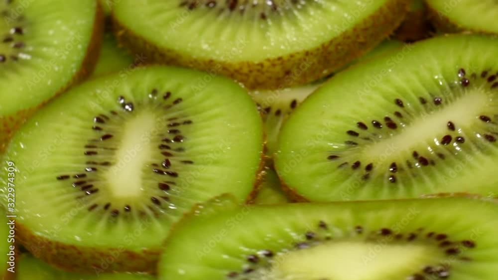 Macro plan of slices of kiwi, rotation. lot of fresh slice of kiwi revolve in a circle in the background. Macro plan of slices of kiwi, rotation. lot of fresh slice of kiwi revolve in a circle in the background.