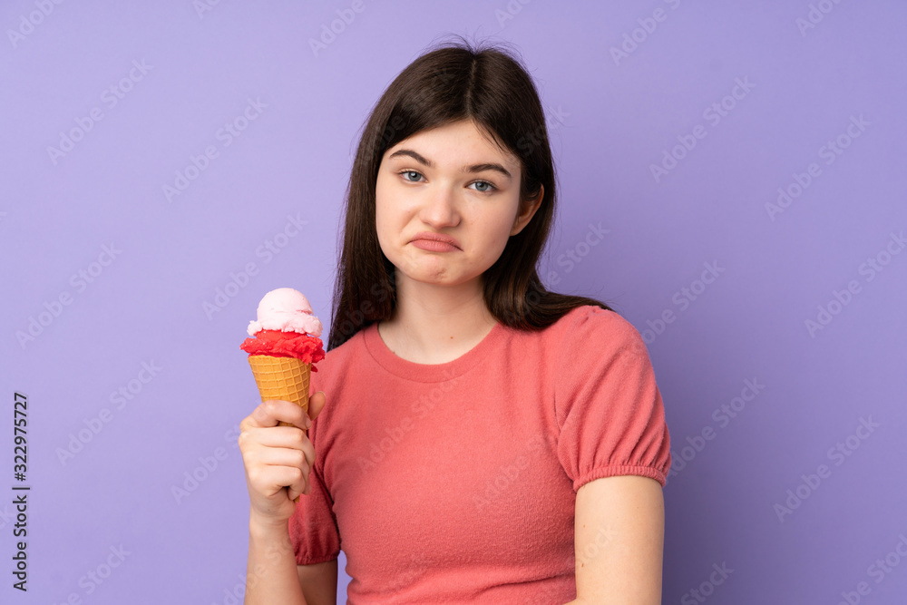 Young Ukrainian teenager girl holding a cornet ice cream over isolated purple background with sad expression Young Ukrainian teenager girl holding a cornet ice cream over isolated purple background with sad expression