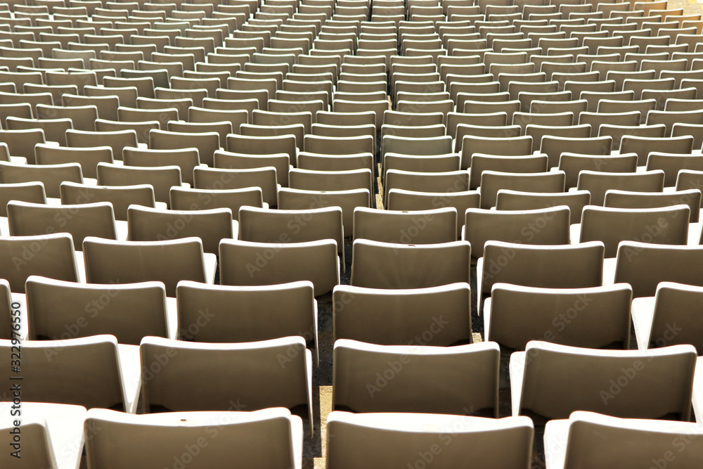 Fototapeta premium A row of empty green seats in a football stadium