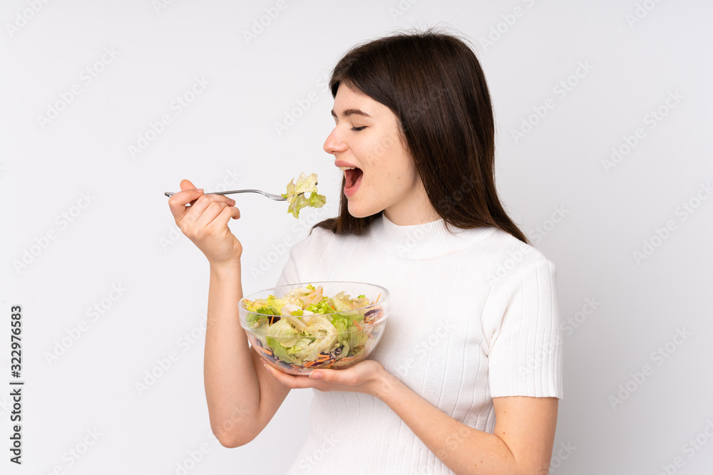 Young Ukrainian teenager girl holding a salad over isolated white background Young Ukrainian teenager girl holding a salad over isolated white background
