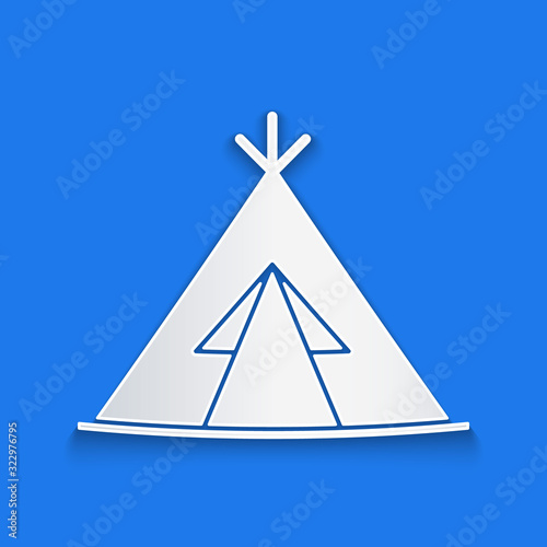 Paper cut Traditional indian teepee or wigwam icon isolated on blue background. Indian tent. Paper art style. Vector Illustration