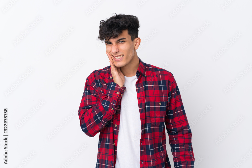 Young Argentinian man over isolated white background with toothache Young Argentinian man over isolated white background with toothache