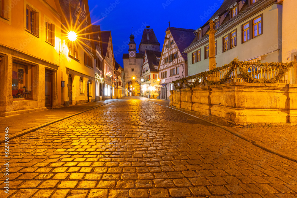 Night street with gate and tower Markusturm in medieval Old Town of Rothenburg ob der Tauber, Bavaria, southern Germany