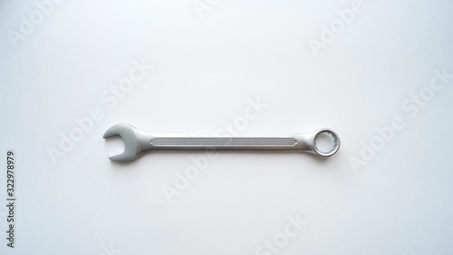 One steel combination wrench lies on a white background.  Repair tool. © ksenikin