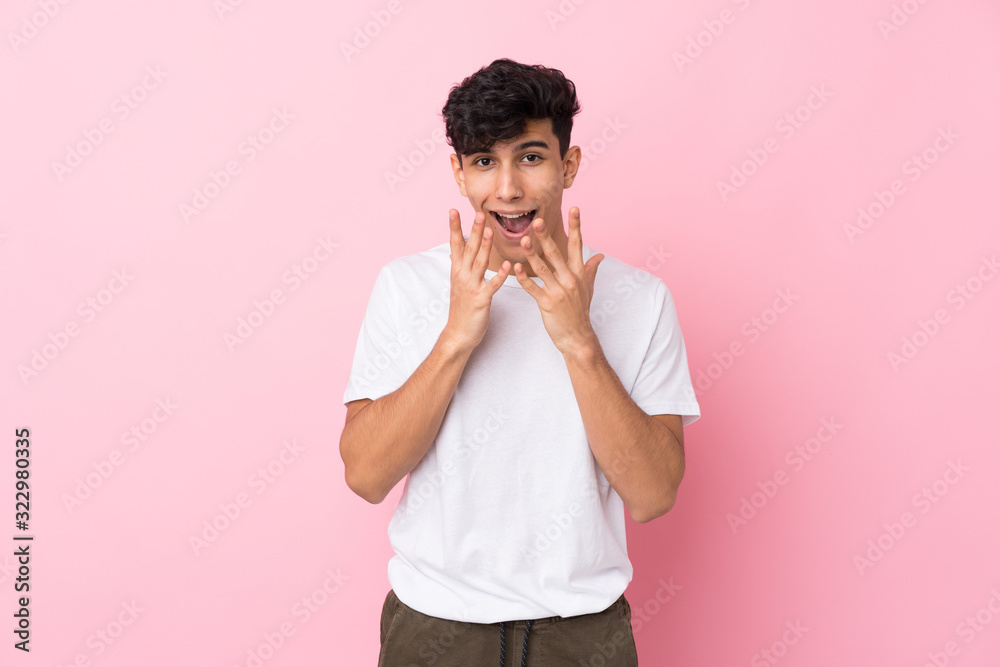 Young Argentinian man over isolated pink background with surprise facial expression Young Argentinian man over isolated pink background with surprise facial expression