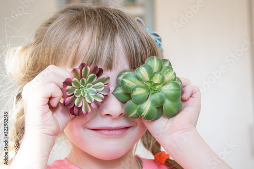 the girl holds the cuttings of the eonium as eyes photo