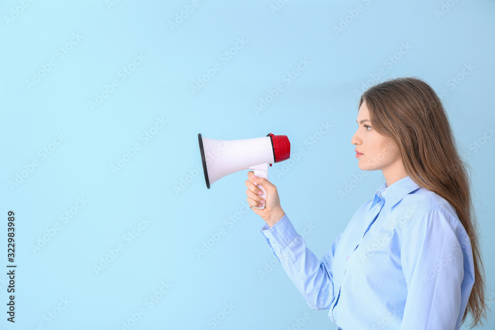 Young businesswoman with megaphone on color background Young businesswoman with megaphone on color background