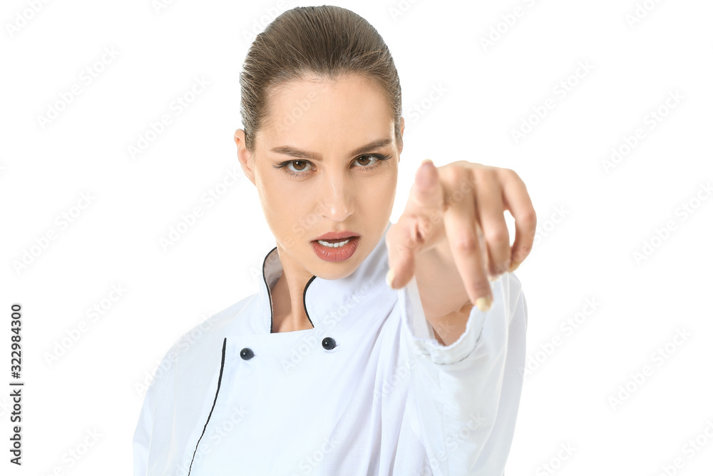 Beautiful female chef pointing at viewer against white background Beautiful female chef pointing at viewer against white background