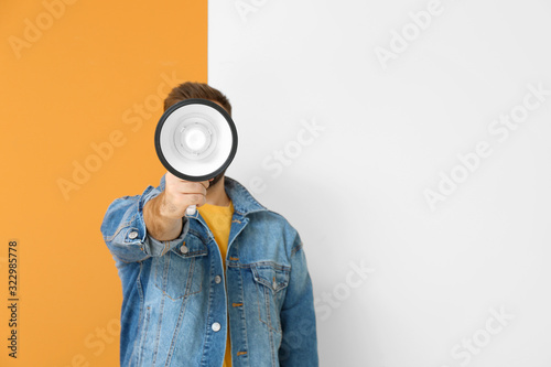 Young man with megaphone on...