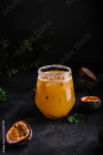 Orange passion fruit beverage in dark and moody style food photography