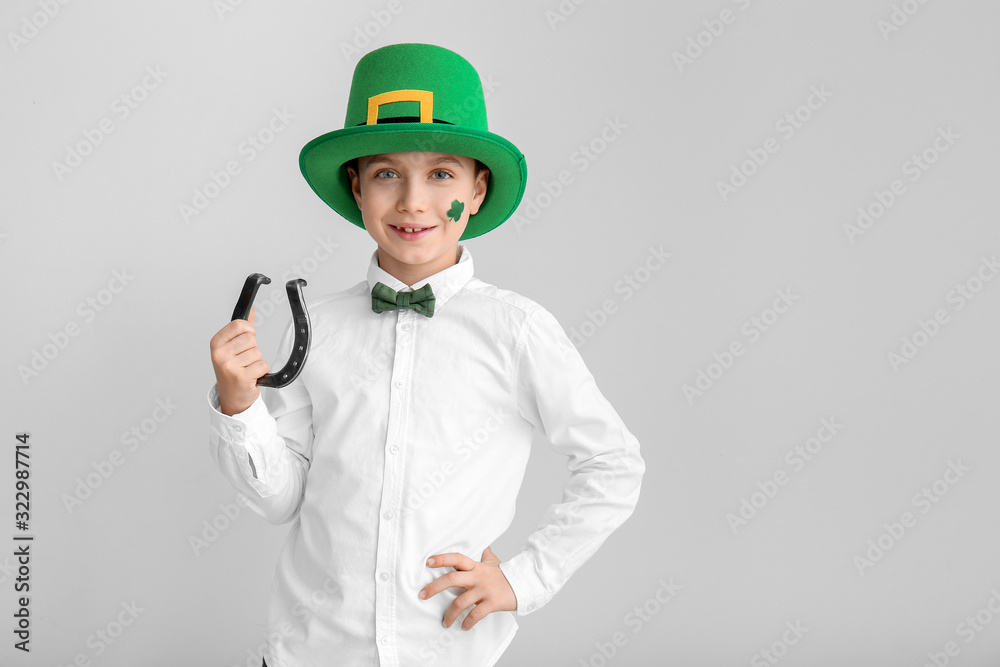 Funny little boy with horseshoe on white background. St. Patrick's Day celebration Funny little boy with horseshoe on white background. St. Patrick's Day celebration