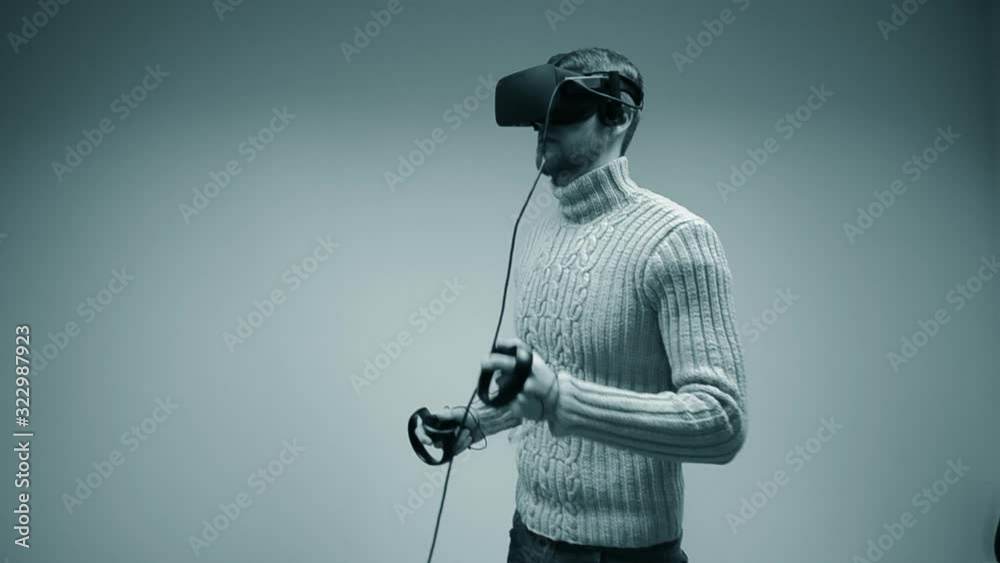 Man in a virtual reality helmet. Young male European Caucasian Man in a virtual reality helmet. Young male European Caucasian
