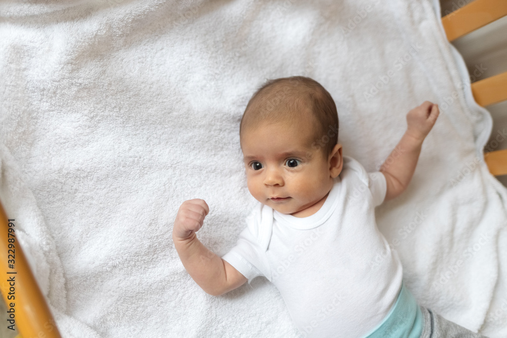 Newborn baby. A little boy in white clothes. Beautiful portrait of a toddler. Big-eyed baby. Newborn baby. A little boy in white clothes. Beautiful portrait of a toddler. Big-eyed baby.