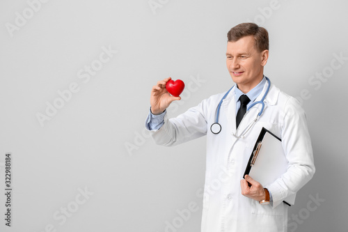 Male cardiologist on light ...