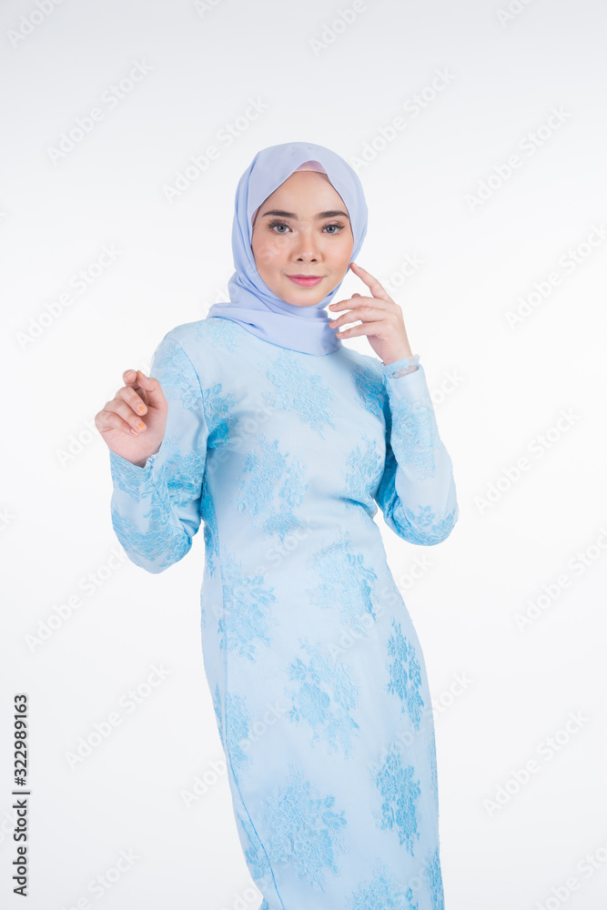 Beautiful Muslim female model wearing pastel blue modern kurung with hijab, a urban lifestyle apparel for Muslim women isolated on white background. Beauty and hijab fashion concept. Half length Beautiful Muslim female model wearing pastel blue modern kurung with hijab, a urban lifestyle apparel for Muslim women isolated on white background. Beauty and hijab fashion concept. Half length