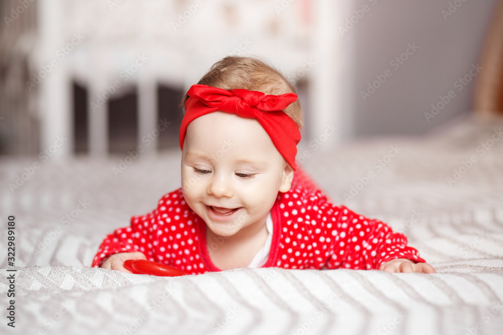 Little newborn girl lies on her tummy. The concept of motherhood, child care and family Little newborn girl lies on her tummy. The concept of motherhood, child care and family
