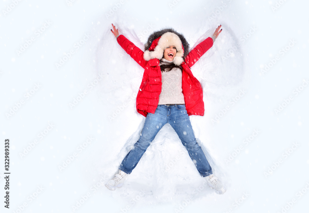 Snow angel concept. Happy woman enjoying first snow, lying in snow and making snow angel. Winter holidays and entertainment background. Snow angel concept. Happy woman enjoying first snow, lying in snow and making snow angel. Winter holidays and entertainment background.