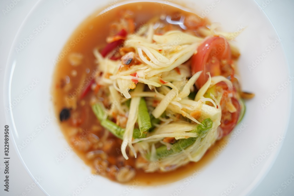 papaya salad in white dish