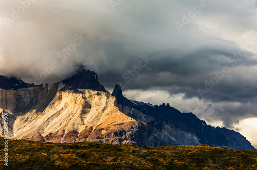 Scenic view on Cerro Paine Grande peak in Patagonia Chile, mountain hidden in cumulus cloud, Torres Del Paine National Park, Patagonia, Andes, Chile.