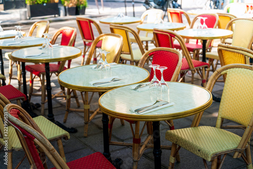Street view of a coffee terrace with tables and chairs  Paris  France