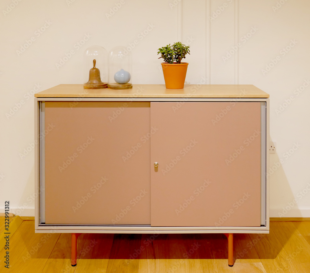 simple modern piece of furniture with plant and ornaments simple modern piece of furniture with plant and ornaments