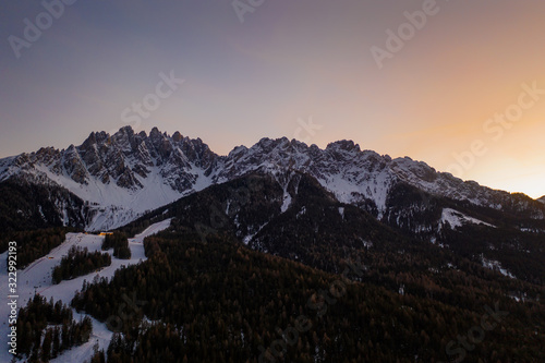 Dolomites Mountain in winter, by San Candido, Alto Adige Italy. Sunrise of ski resort Monte Baranci Haunold. Aerial drone shot in january 2020