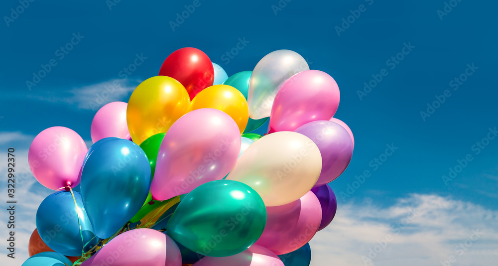 Multi-colored balloons on blue sky background
