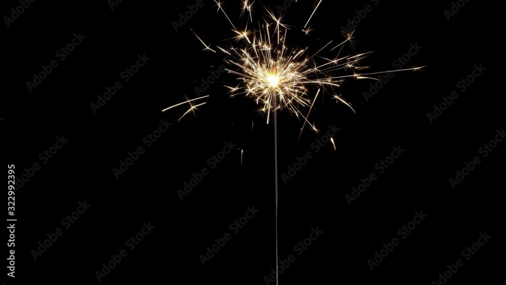 Sparkler on black background . Gun powder sparks shot against deep dark background. Burning fuse or bengal fire Isolated. Lightening Christmas sparkler. Sparkler on black background . Gun powder sparks shot against deep dark background. Burning fuse or bengal fire Isolated. Lightening Christmas sparkler.