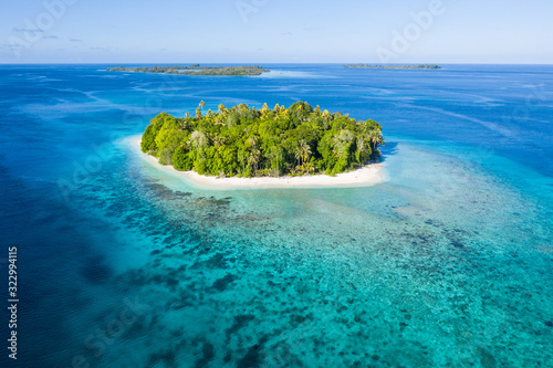 Seen from the air, a remote, tropical island lies amid the Molucca Sea in Indonesia. This beautiful region is thought to be amid the world's epicenter of marine biodiversity.