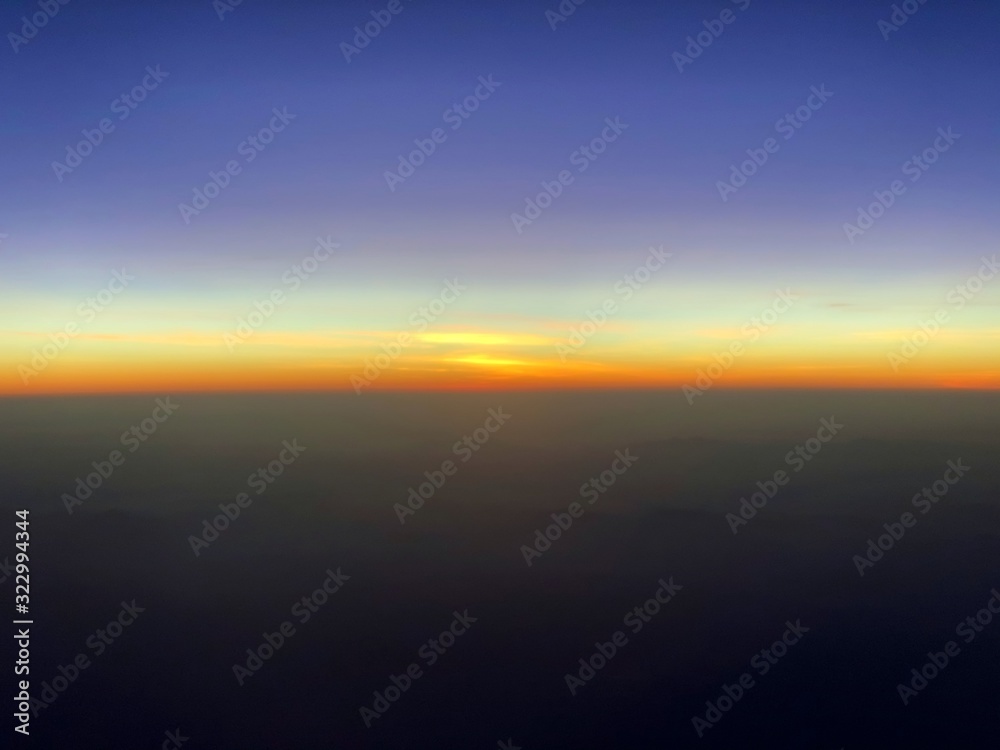 The sun set at the horizon that seen from the airplane