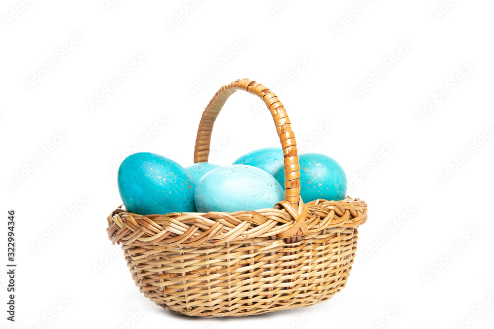 Easter eggs in a basket on a white background, place for text, top view, isolation,
